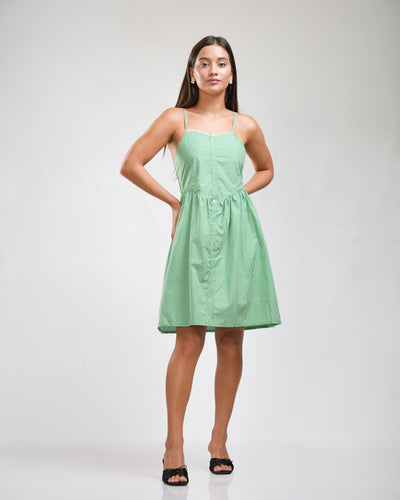 Noirelle sage green mini dress, camisole straps, worn by a model