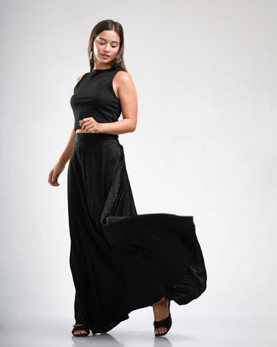 Noirelle black skirt, flowing silhouette, worn by a model