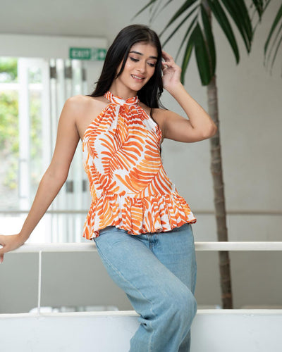Noirelle sunset-orange top, palm motif print, worn by a model