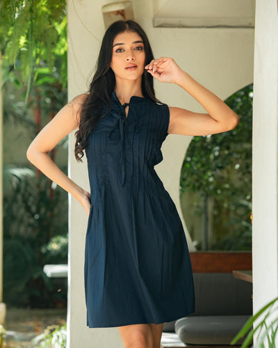 Noirelle midnight navy mini dress, pin-tuck pleated bodice, worn by a model